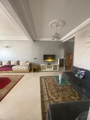 a living room with a couch and a tv at Luxury Apartment Meknes in Meknès