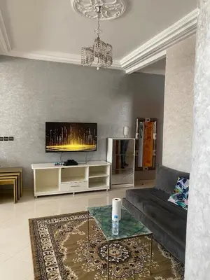 a living room with a couch and a tv at Luxury Apartment Meknes in Meknès