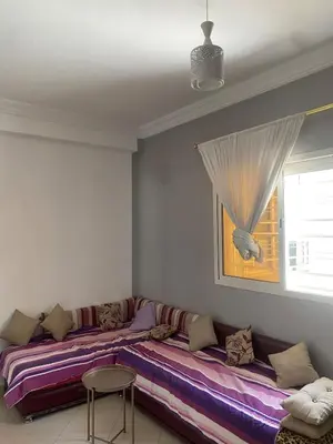 a living room with two beds and a window at Luxury Apartment Meknes in Meknès