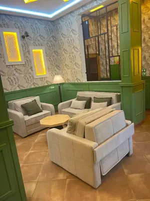 a living room with two couches and a table at Vintage Green House in Fès