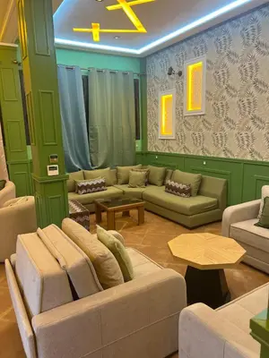 a large living room with couches and a table at Vintage Green House in Fès