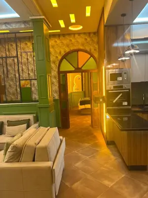 a living room with a couch and a kitchen at Vintage Green House in Fès