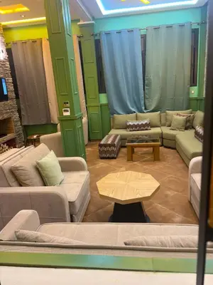 a living room with couches and a coffee table at Vintage Green House in Fès