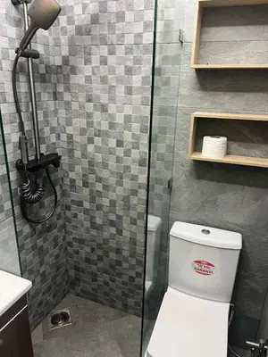 a bathroom with a toilet and a glass shower at Vintage Green House in Fès