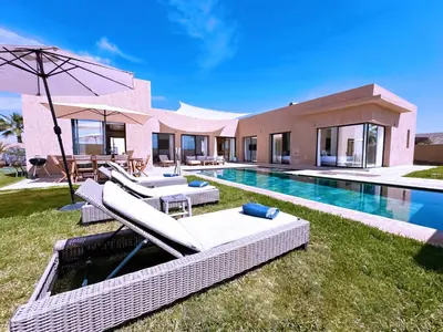 a villa with a swimming pool and a house at villa Elyssa !Confort & modern avec Piscine privée in Marrakech