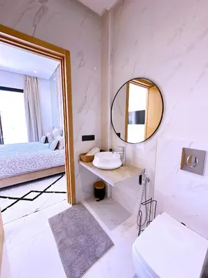 a white bathroom with a sink and a mirror at villa Elyssa !Confort & modern avec Piscine privée in Marrakech