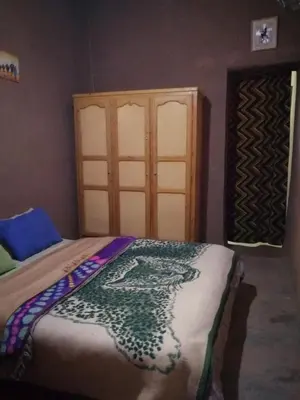 a bedroom with a bed and a window and a door at Dar itran in Mhamid