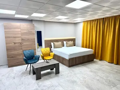 a bedroom with a bed and two chairs in it at Studio plein centre-ville ! in Fès