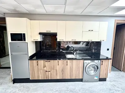 a kitchen with a sink and a washing machine at Studio plein centre-ville ! in Fès