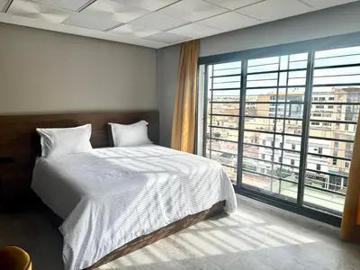 a bedroom with a large bed and a large window at Studio plein centre-ville ! in Fès