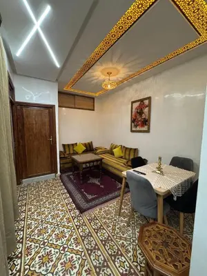 a living room with a couch and a table at Appartement Dar LALA 2 in Fès