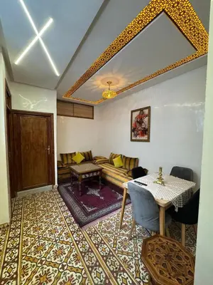 a living room with a couch and a table at Appartement Dar LALA 2 in Fès