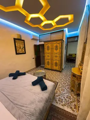 a bedroom with a bed with black bow ties on it at Appartement Dar LALA 2 in Fès