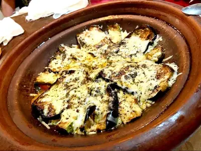a brown plate of food on a table at Fabulos Merzouga Luxury Camp in Hassilabied