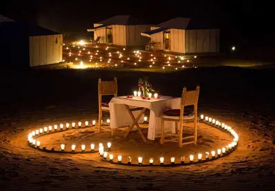 a table with chairs and a circle of lights at Fabulos Merzouga Luxury Camp in Hassilabied