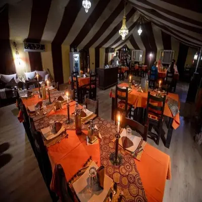an overhead view of a restaurant with tables and chairs at Golden Sahara camp in Merzouga