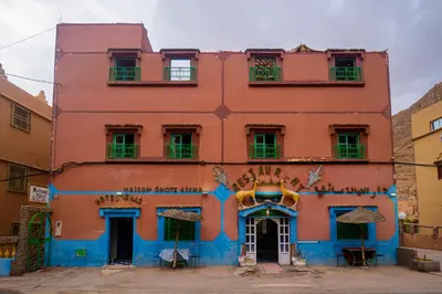 an orange building with blue paint on it at hotel dar aicha in Tinerhir