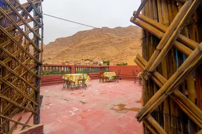 a view of a patio with tables and chairs at hotel dar aicha in Tinerhir