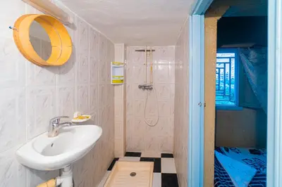 a bathroom with a sink and a shower at hotel dar aicha in Tinerhir