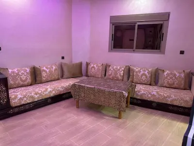 a living room with a couch and a window at apartment for guests in Demnat