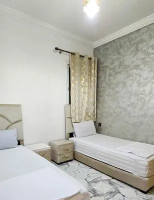 a room with two beds and a window at Appart Hotel Bab Fes Medina - For Families & Travelers in Fès