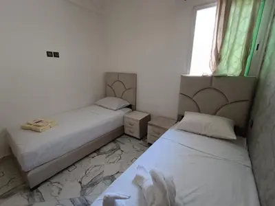 a room with two beds and a window at Appart Hotel Bab Fes Medina - For Families & Travelers in Fès