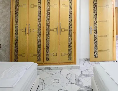 a room with two wooden cabinets and marble floors at Appart Hotel Bab Fes Medina - For Families & Travelers in Fès