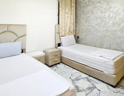 two beds in a small room with two bedsvisor at Appart Hotel Bab Fes Medina - For Families & Travelers in Fès