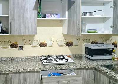 a kitchen with a stove and a counter top at Appart Hotel Bab Fes Medina - For Families & Travelers in Fès