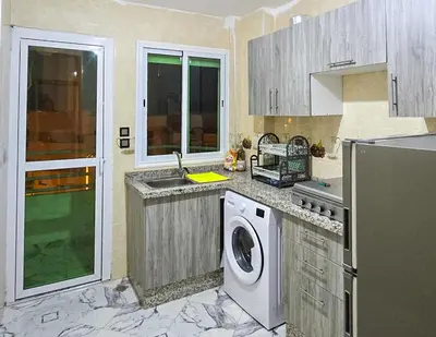 a kitchen with a sink and a washing machine at Appart Hotel Bab Fes Medina - For Families & Travelers in Fès