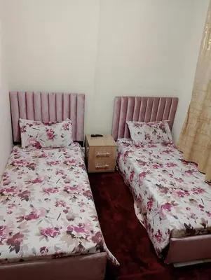 a bedroom with two beds and a night stand at apartment near Super Market in Meknès