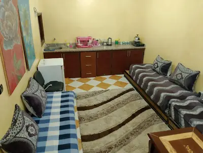a room with two beds and a counter at شقة مفروشة بمكناس قرب مركز التسوق مرجان in Meknès