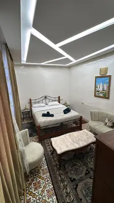 a bedroom with two beds and a skylight at Appartement Dar LALA 1 in Fès