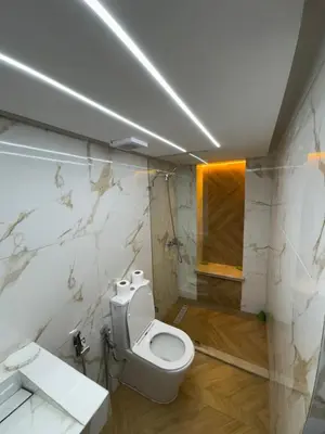 a bathroom with a white toilet and a sink at Appartement Dar LALA 1 in Fès