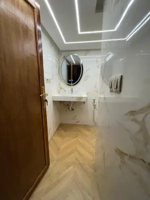 a bathroom with a sink and a mirror at Appartement Dar LALA 1 in Fès