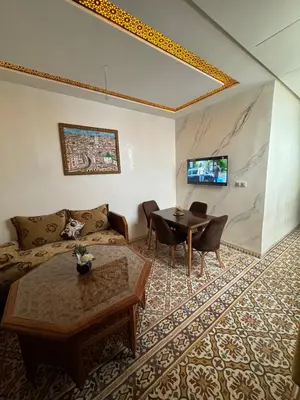 a living room with a couch and a table at Appartement Dar LALA 1 in Fès