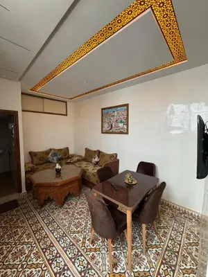 a living room with a couch and a table at Appartement Dar LALA 1 in Fès