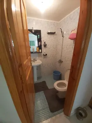 a bathroom with a toilet and a sink at Location Appartement pour Familles in Fès