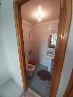 a small bathroom with a toilet and a sink at Location Appartement pour Familles in Fès