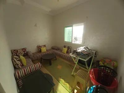 a living room with two couches and a window at Location Appartement pour Familles in Fès