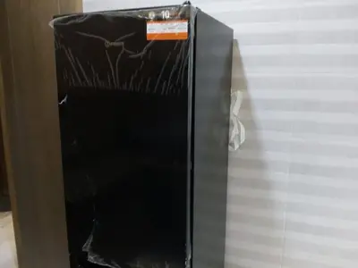a black refrigerator with a sticker on the side of it at Calme Climatisé Bien Situé Fibre 92Mbs à Bourmana in Fès