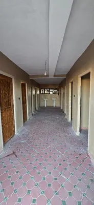 an empty hallway with a tile floor in a building at Touaregs Camp Erg Lihoudi in Mhamid