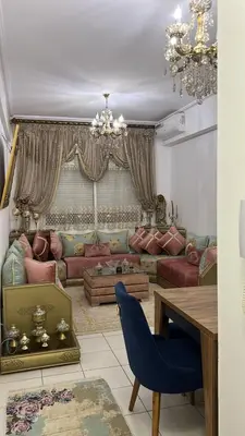 a living room with a couch and a table at واد فاس طريق مكناس تجزئة البركه قرب طريق الجامعه المتوسطه لاغوميد in Fès