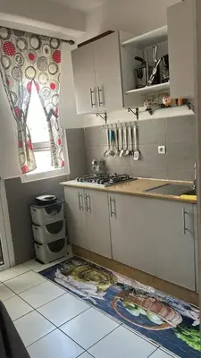 a kitchen with white cabinets and a window at واد فاس in Fès
