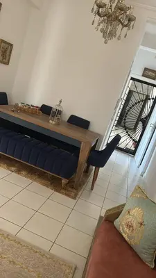 a living room with a blue couch and a table at واد فاس in Fès
