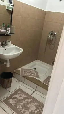 a bathroom with a shower and a sink and a tub at واد فاس in Fès