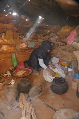 a woman is laying on the ground in a dirty room at Private Wild Tent Experience M'Hamid in Mhamid