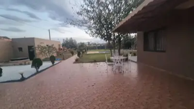 a brick walkway with a table and chairs on it at Coin des bons moments in Marrakech