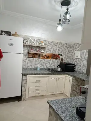 a kitchen with a white refrigerator and a counter at Coin des bons moments in Marrakech