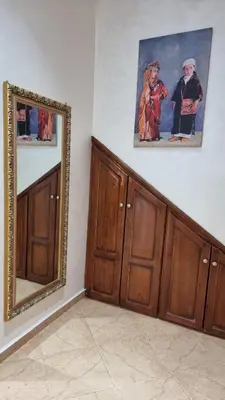 a room with wooden cabinets and a mirror on the wall at Maison Taha in Azrou